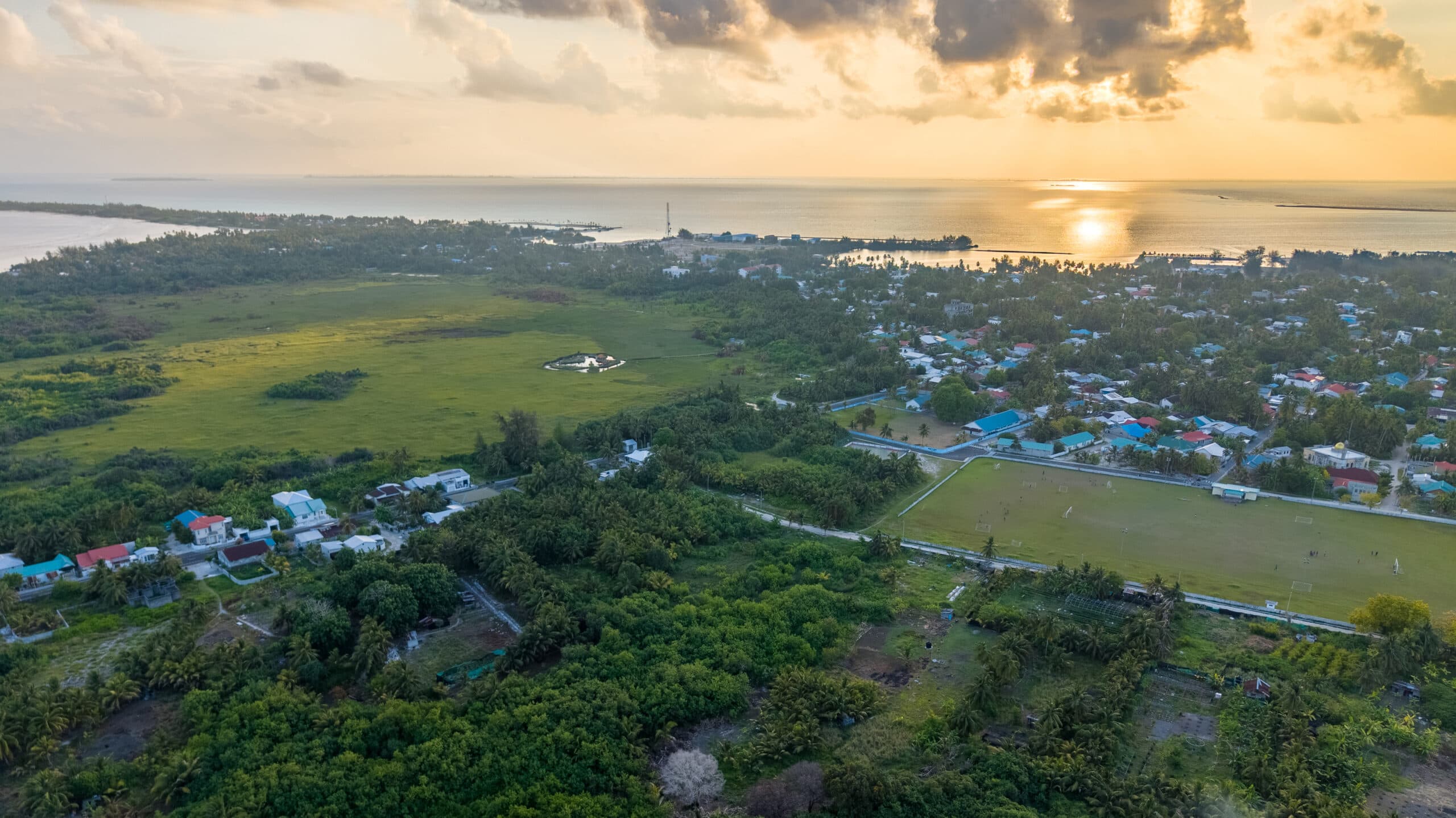 Aerial view of island life and reef in Addu Atoll
