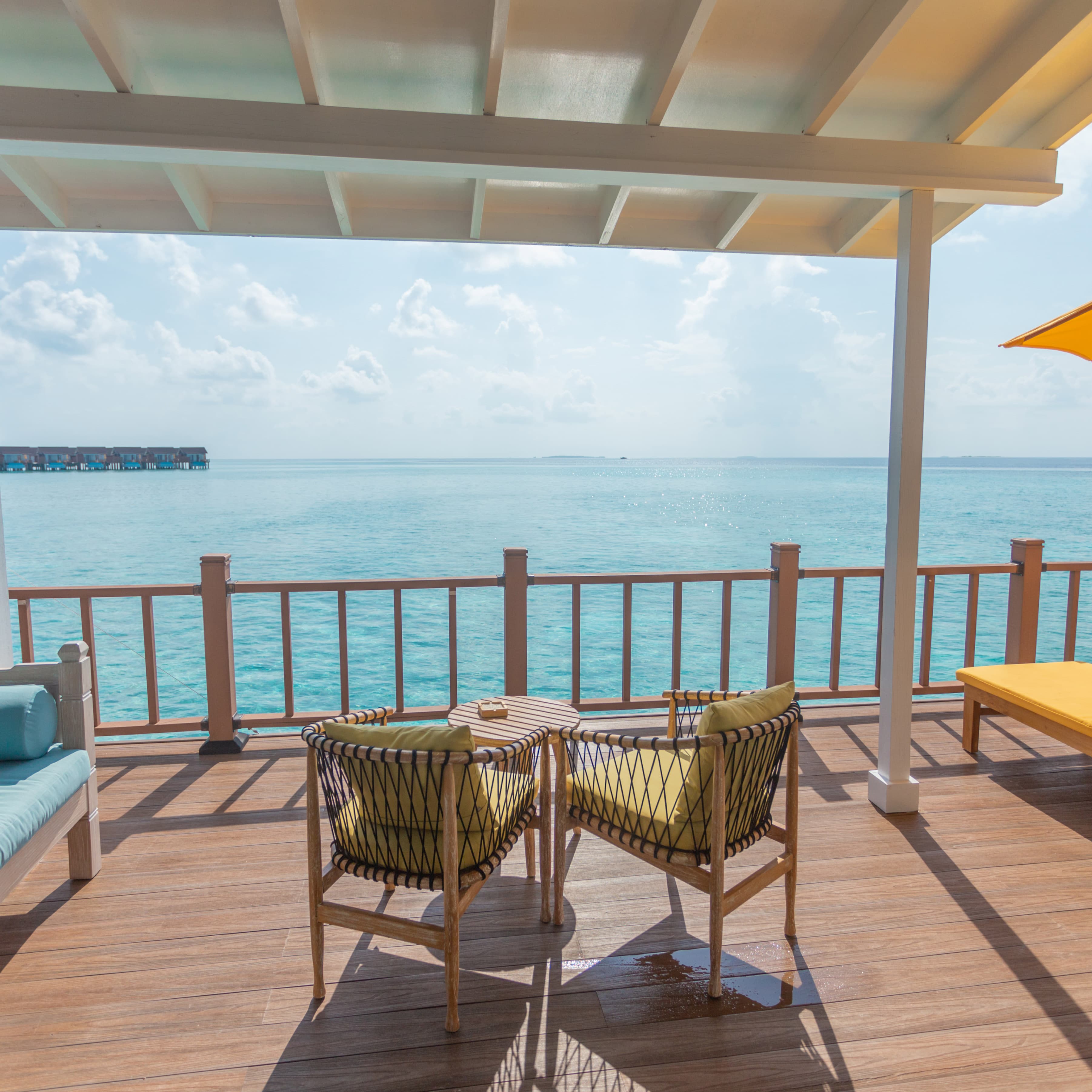 Private water-villa deck overlooking a clear Maldives lagoon